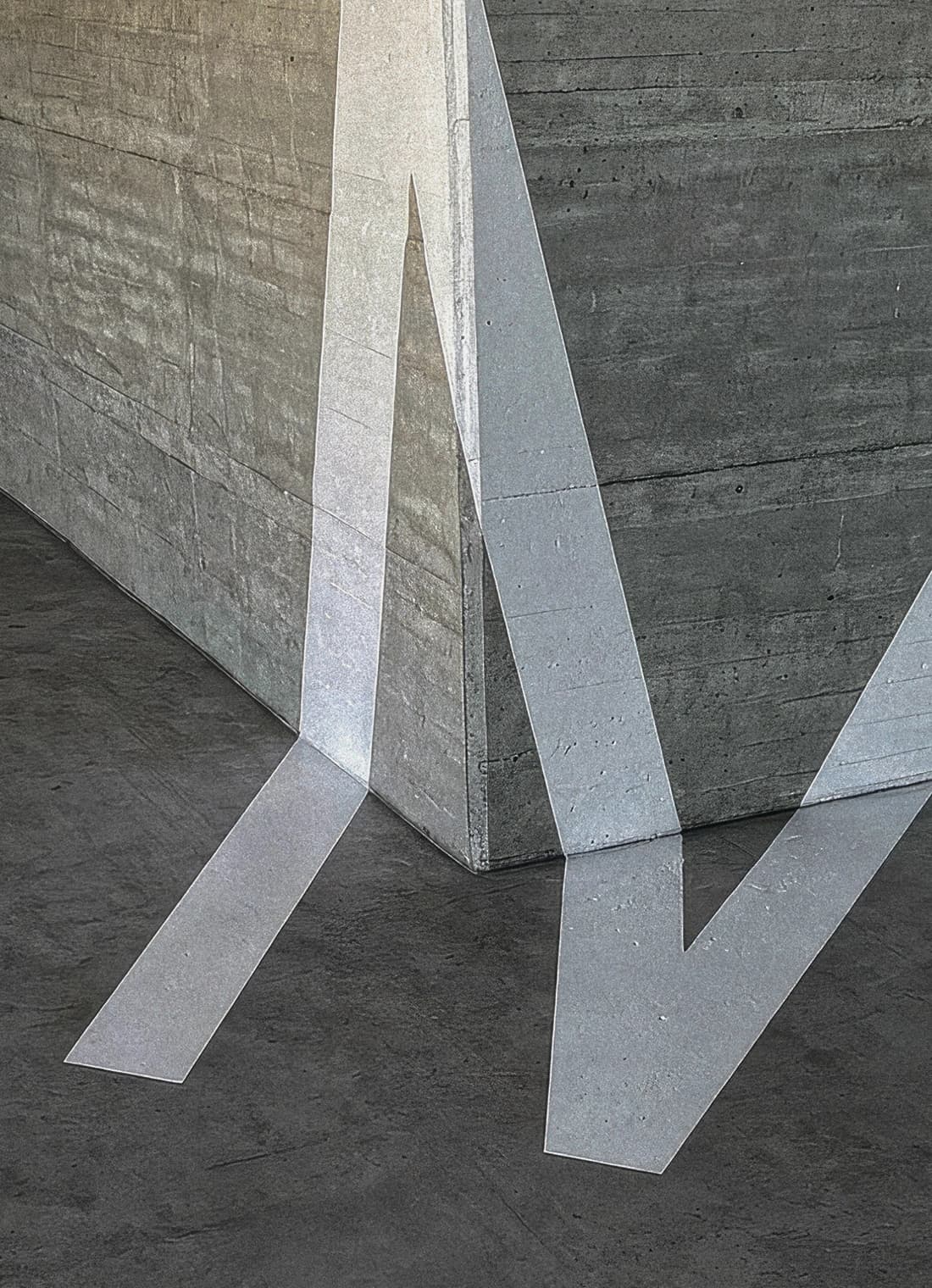 White M crosses a concrete pillar and floor